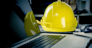 Construction hard hat next to computer